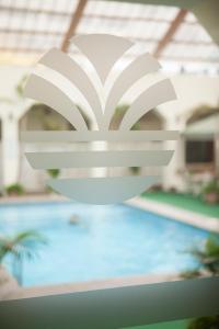 a white object hanging over a swimming pool at Hotel Ramada in Guayaquil