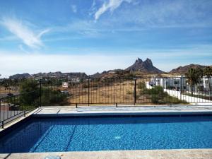 a swimming pool with a view of the mountains at Los Jitos Hotel & Suites in San Carlos