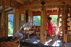 a woman standing in a room in a wooden house at Tres Continentes in San José de Maipo