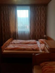 A bed or beds in a room at Penzion u Draka