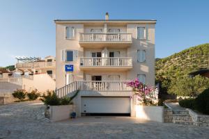 a large apartment building with a garage at Sun House Apartments in Bol