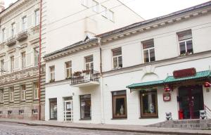 a white building on the side of a street at In Astra in Vilnius