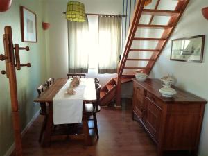 a dining room with a table and a staircase at Laurel Beach House in Lourinhã