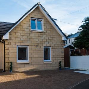 una casa con dos ventanas y una valla en Alma Villa en Falkirk