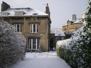 uma casa com neve no chão em frente dela em The Corner House Bed & Breakfast em Whitehaven