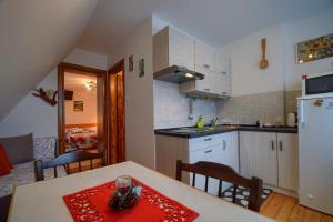 a kitchen with a table with a red napkin on it at Agro u Marka in Bukowina Tatrzańska