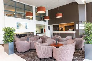 a living room filled with lots of furniture at Heartland Hotel Auckland Airport in Auckland