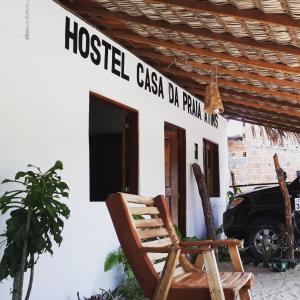 a house with a rocking chair outside of it at Casa da Praia.Atins in Atins