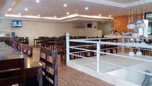 a dining room with wooden tables and chairs at Columbus Plaza Hotel in General Santos