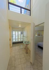 
a bathroom with a sink, toilet and a window at 230 Scenic Drive in Bilambil Heights
