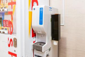 a pay phone in the side of a refrigerator at Hotel Villa Fontaine Tokyo-Hamamatsucho in Tokyo