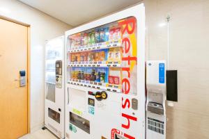 a vending machine in a room with soda at Hotel Villa Fontaine Tokyo-Hamamatsucho in Tokyo