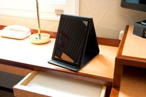 a tablet computer sitting on a table on a desk at Hotel Villa Fontaine Tokyo-Hamamatsucho in Tokyo