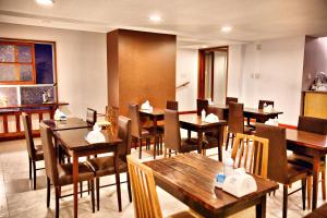 a dining room with wooden tables and chairs at Galeon Mar del Plata Hotel in Mar del Plata