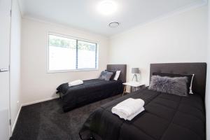 A bed or beds in a room at Executive Home Accommodation 34