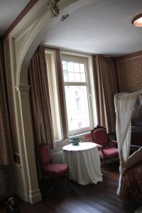 a room with a table and chairs and a window at La Porte Cochère in Ieper