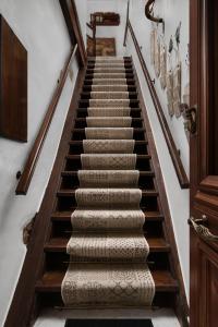 a winding staircase with wooden railings and carpet at Dream Art Studios in Chania