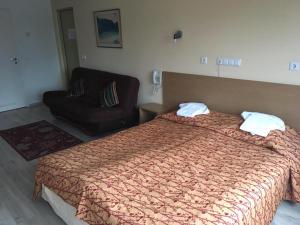 Ένα ή περισσότερα κρεβάτια σε δωμάτιο στο Carolina Hotel