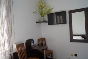 a room with a table and a mirror on the wall at Uslugi hotelowe A1 in Łódź