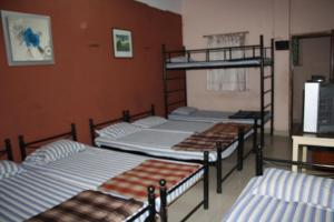 a group of four bunk beds in a room at Minerva Residency in Bangalore