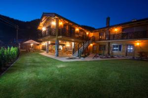 a large house with a yard at night at Chata Piecky in Hrabušice