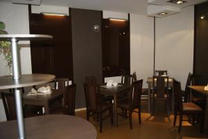 a dining room with wooden tables and chairs at Uslugi hotelowe A1 in Łódź