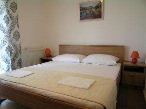 a bedroom with a bed with two towels on it at Apartments Magdalena in Pag