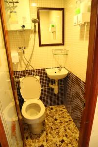 a bathroom with a toilet and a sink at Euro Hostel in Hong Kong