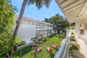 an exterior view of a building with palm trees at Epic Unawatuna in Unawatuna