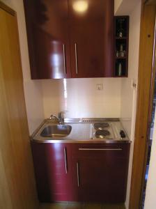 a kitchen with a sink and a stove at Apartments Magdalena in Pag
