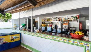 a bar with a counter with a lot of drinks at Blue Sea Costa Bastian in Costa Teguise