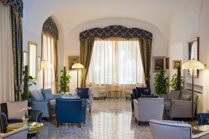 a living room filled with furniture and a large window at Hotel La Reginella Resort & Spa in Ischia