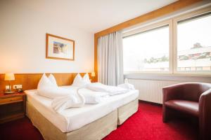 En eller flere senger på et rom på Am Neutor Hotel Salzburg Zentrum