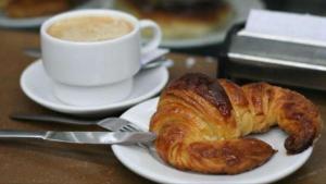 a plate with a croissant and a cup of coffee at Stelle Di Mari in Milan