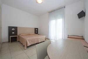 Postel nebo postele na pokoji v ubytování Hotel Nettuno