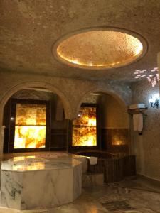 a large room with two windows and a ceiling at Oread Cave Suites in Ürgüp