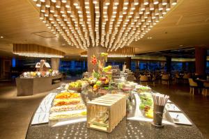 a buffet table in a hotel with food on it at Graceland Khaolak Beach Resort- SHA Extra Plus in Khao Lak