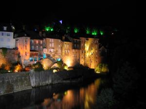 a city at night with a river and buildings at Entre Pyrenees Et Atlantique in Oloron-Sainte-Marie