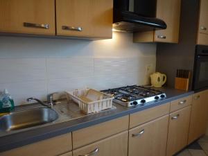 a kitchen with a sink and a stove at Entre Pyrenees Et Atlantique in Oloron-Sainte-Marie