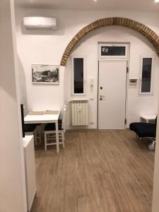 a living room with a table and a desk at San Lorenzo University flat in Rome