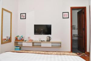 a bedroom with a bed and a tv on a wall at Phi Long Hotel in Tuy Hoa +68 photos
