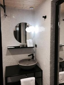 a bathroom with a sink and a mirror at Just Inn Taipei (Xin Yi) in Taipei