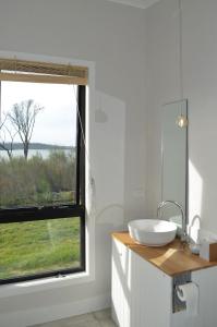 a bathroom with a sink and a window at Flotsam Studio Dunalley in Dunalley