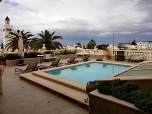 a swimming pool on the roof of a building at Maison d'Hôtes Dar Ennassim in La Marsa