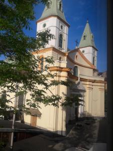 a large white building with a clock tower at Lviv Rest Zelena in Lviv