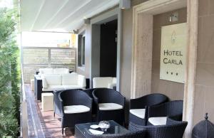 a restaurant with chairs and tables on a patio at Hotel Carla in Levanto