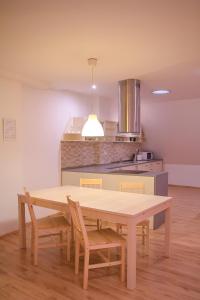 a kitchen with a wooden table and chairs in a room at Old Town Apartment in Trenčín +5 photos