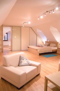 a living room with two beds and a couch at Old Town Apartment in Trenčín