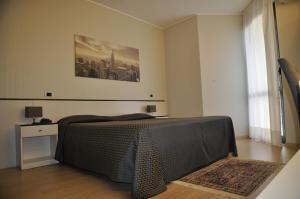 Postel nebo postele na pokoji v ubytování Hotel Est Piombino