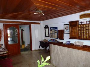 a restaurant with a counter and a table in a room at Vlachakis Hotel in Stalida